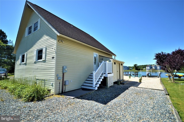 view of side of home featuring a water view