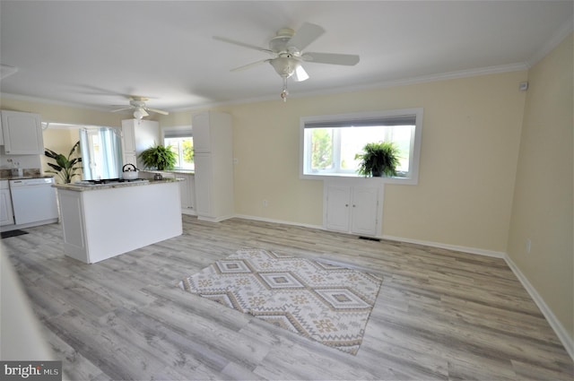 kitchen with a center island, ornamental molding, dishwasher, and white cabinets