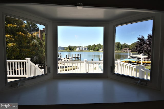 unfurnished sunroom with a water view