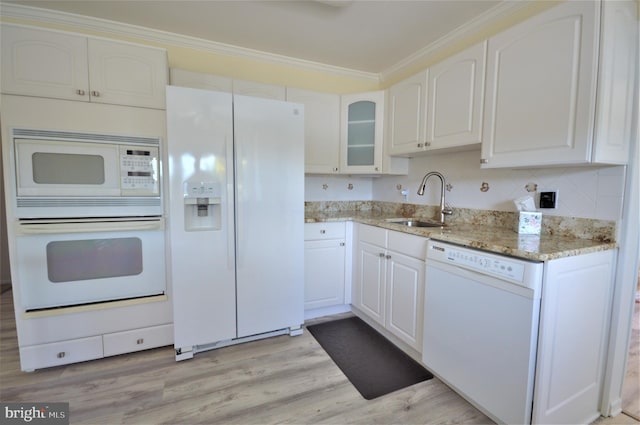 kitchen with sink, light stone counters, crown molding, white appliances, and white cabinets