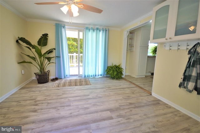 interior space with ceiling fan, ornamental molding, and light hardwood / wood-style floors