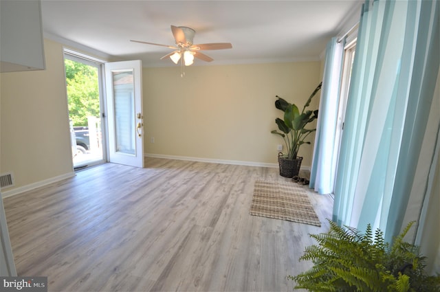 interior space featuring crown molding, light hardwood / wood-style flooring, and ceiling fan