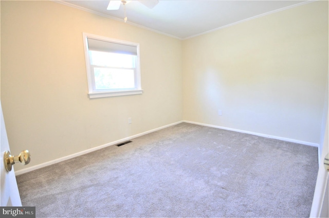 carpeted empty room featuring crown molding and ceiling fan