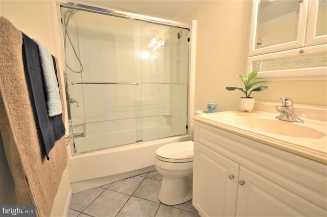 full bathroom featuring tile patterned flooring, vanity, bath / shower combo with glass door, and toilet