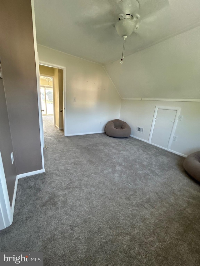 bonus room featuring dark colored carpet and vaulted ceiling