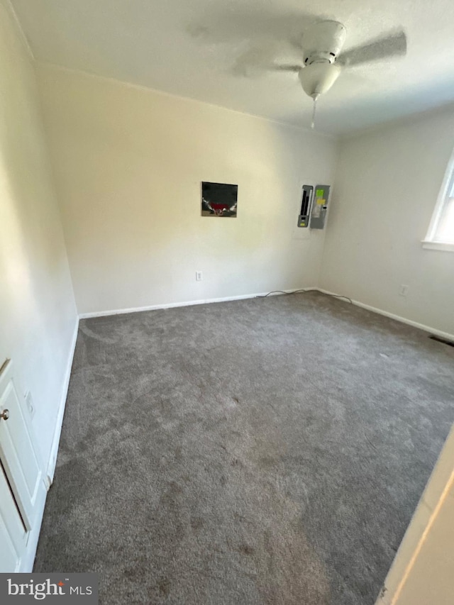 carpeted spare room with ceiling fan