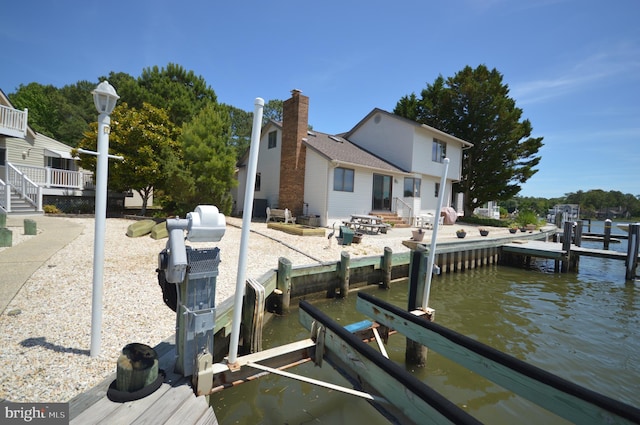 exterior space featuring a water view and a patio area