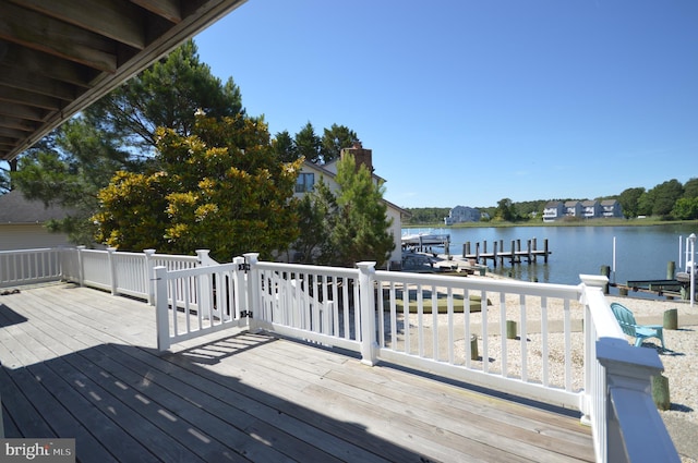 deck with a water view and a boat dock