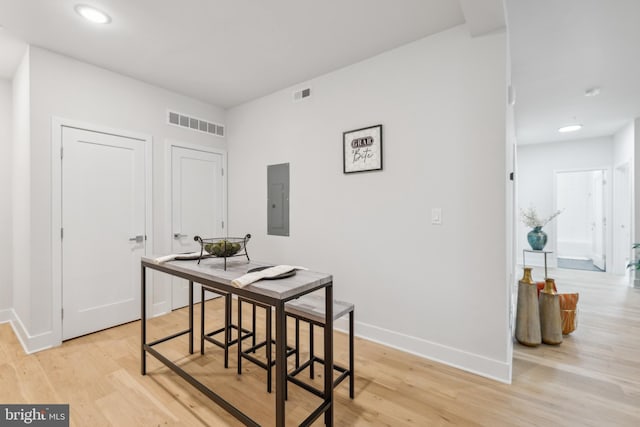 dining room featuring light wood-type flooring and electric panel