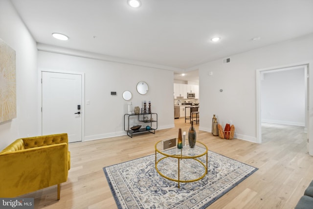 living room with light hardwood / wood-style flooring