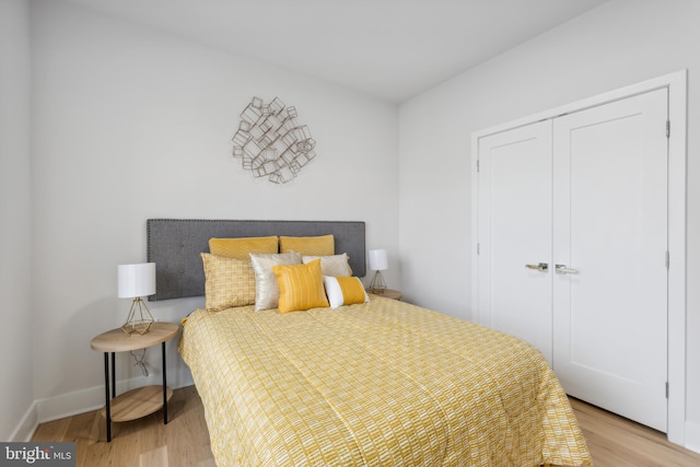 bedroom with a closet and light hardwood / wood-style floors