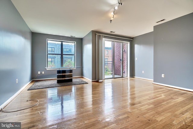 spare room with track lighting and light hardwood / wood-style floors