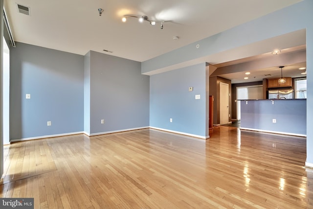 unfurnished living room with light hardwood / wood-style floors