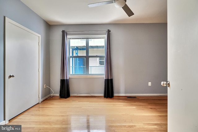 unfurnished room with ceiling fan and light hardwood / wood-style floors