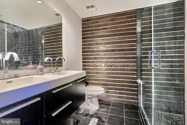 bathroom with toilet, wood walls, and vanity