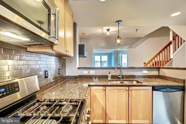 kitchen featuring stainless steel appliances, decorative backsplash, light brown cabinets, and sink