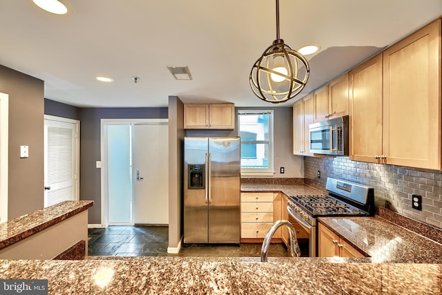 kitchen featuring decorative backsplash, light brown cabinets, appliances with stainless steel finishes, and stone counters