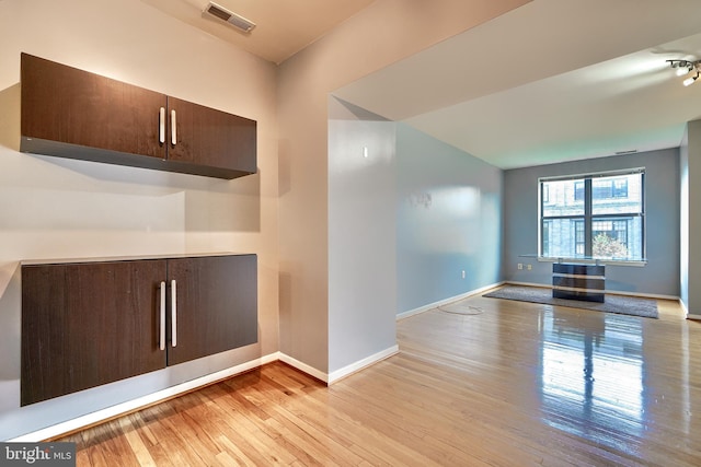 interior space featuring light hardwood / wood-style floors and dark brown cabinetry