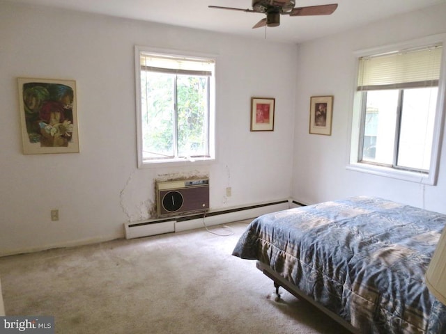 bedroom with light carpet, baseboard heating, ceiling fan, and a wall unit AC