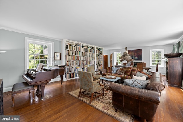 living room featuring hardwood / wood-style floors, a healthy amount of sunlight, and ornamental molding