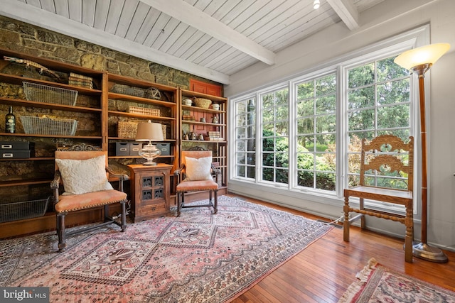 sitting room with beamed ceiling, hardwood / wood-style flooring, and wood ceiling