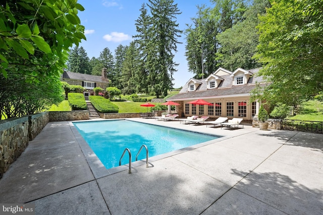 view of swimming pool with a patio area