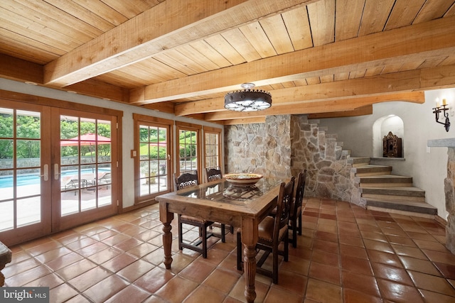 dining room with tile patterned flooring, beam ceiling, wooden ceiling, and french doors