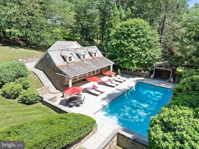 view of swimming pool featuring a gazebo, an outbuilding, a patio, and a lawn