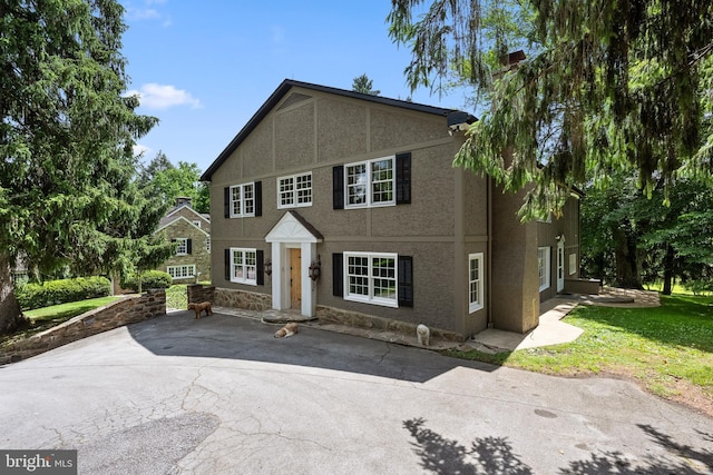 view of front of home featuring a patio area and a front lawn