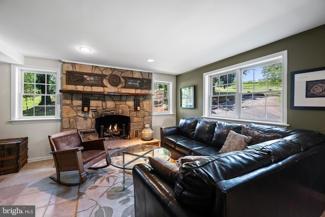 living room featuring a stone fireplace