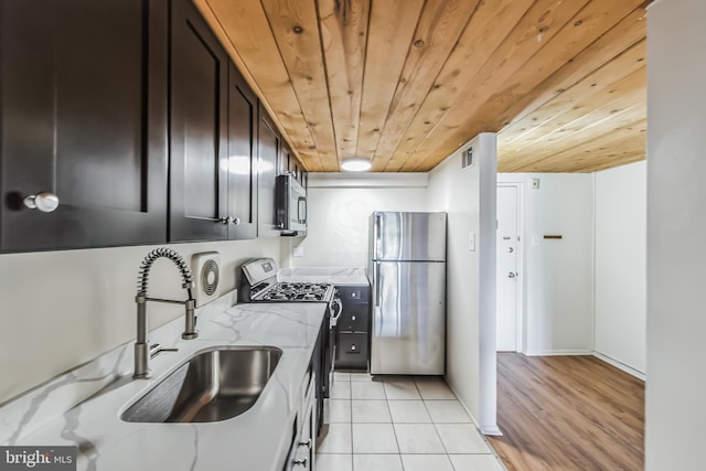 kitchen featuring sink, light stone countertops, light hardwood / wood-style floors, wood ceiling, and stainless steel appliances