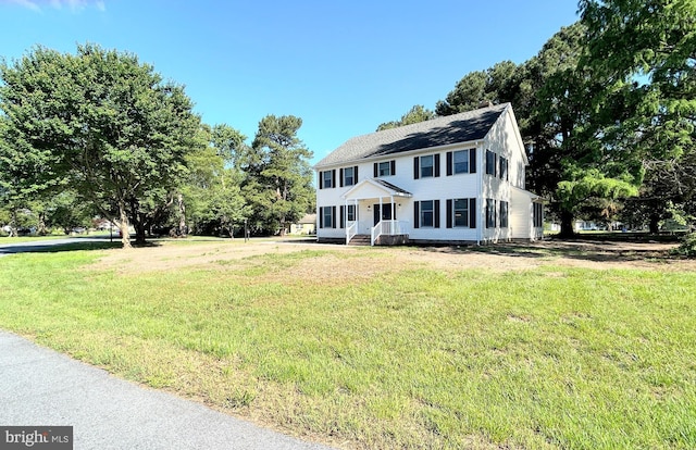 colonial home with a front lawn