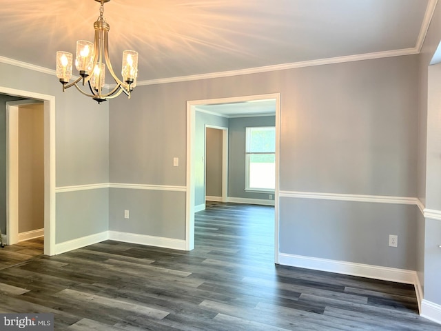 spare room featuring ornamental molding, an inviting chandelier, and dark wood-type flooring