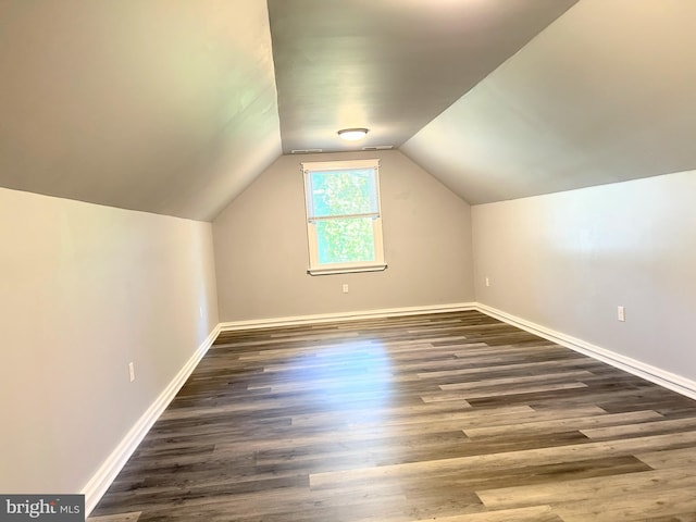 bonus room featuring dark hardwood / wood-style floors and vaulted ceiling