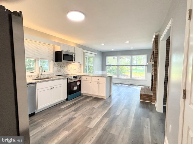 kitchen with a healthy amount of sunlight, sink, and stainless steel appliances