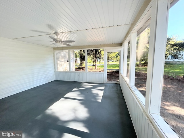 unfurnished sunroom with ceiling fan