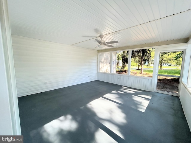 unfurnished sunroom with ceiling fan