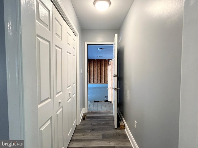 hall with dark hardwood / wood-style flooring