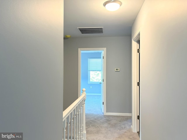 hallway with light colored carpet