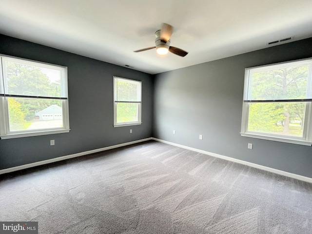 empty room with ceiling fan and carpet floors