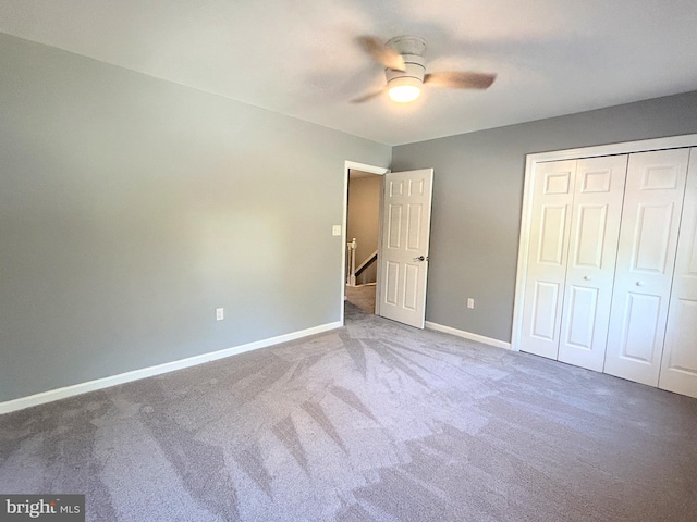 unfurnished bedroom featuring ceiling fan, a closet, and carpet floors