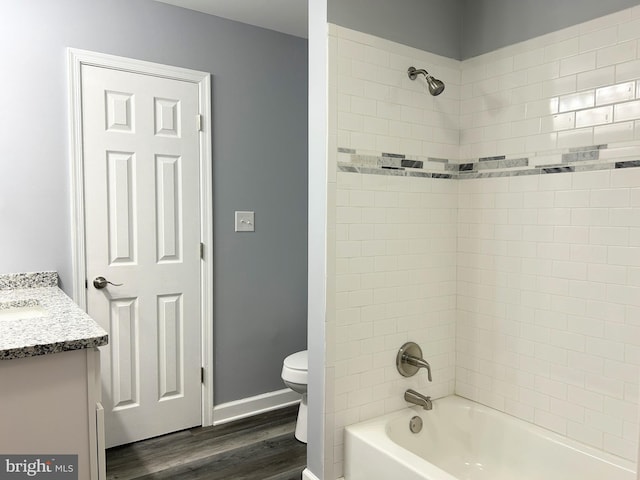 full bathroom with wood-type flooring, vanity, toilet, and tiled shower / bath