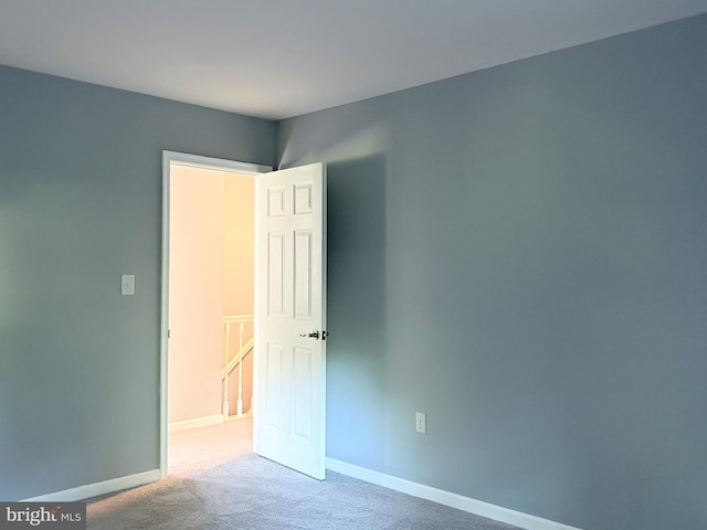 empty room featuring light colored carpet