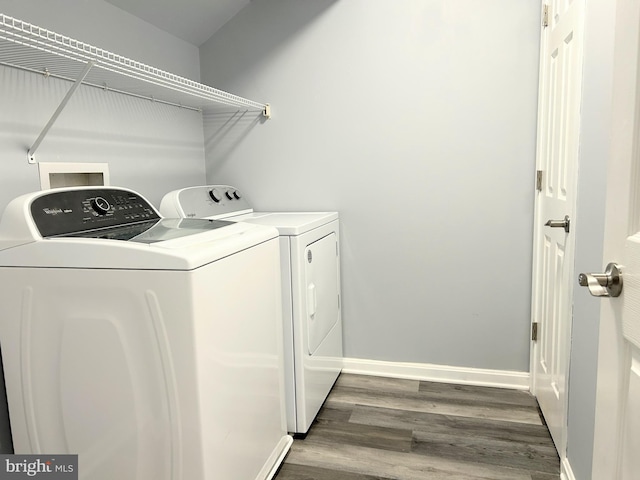 laundry room featuring washer and clothes dryer and dark wood-type flooring