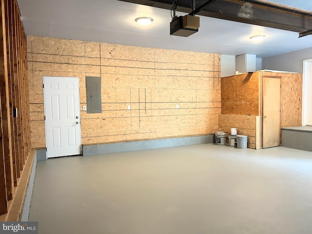 garage with electric panel and a garage door opener