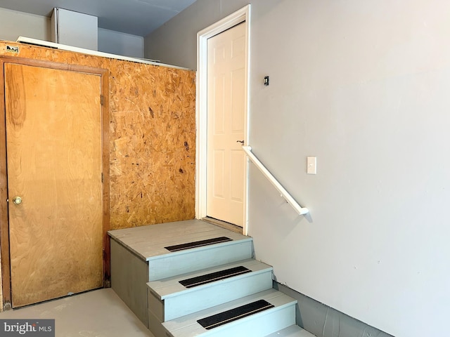 staircase with concrete flooring