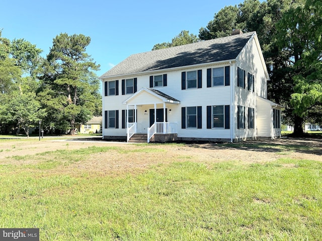 colonial-style house featuring a front lawn