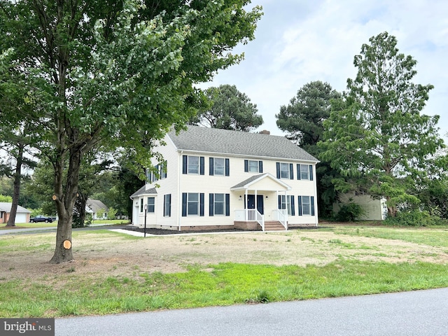 colonial-style house with a front lawn