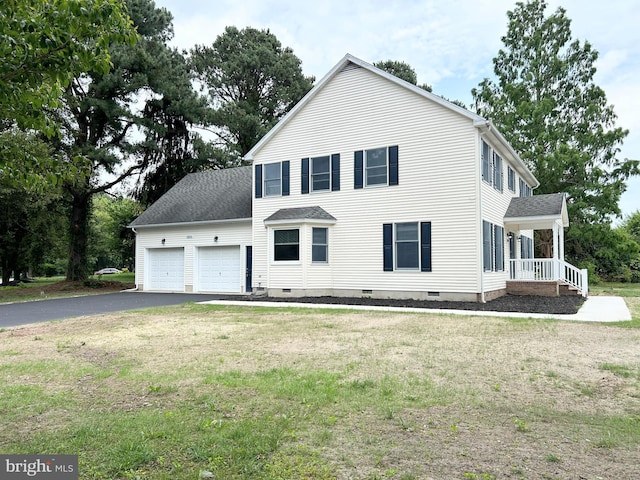 view of front of home featuring a front yard and a garage