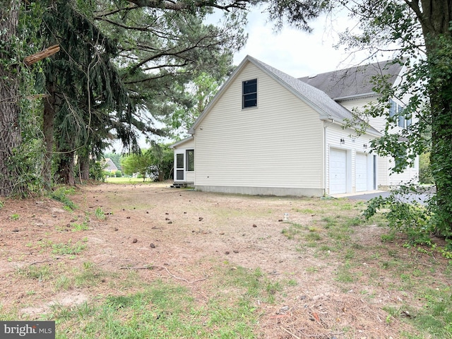 view of side of home with a garage